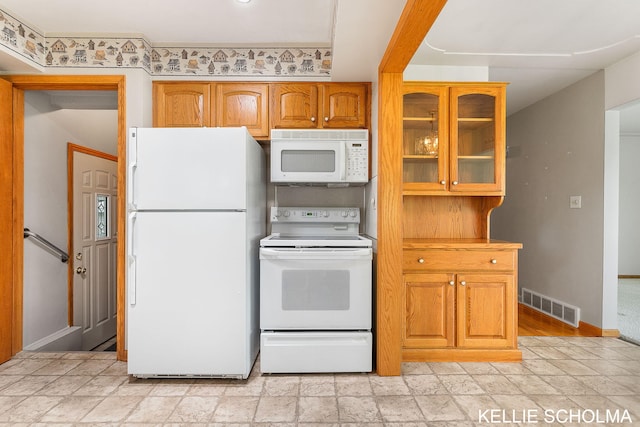 226 Palms St SW, Grand Rapids, MI 49548 - kitchen with white appliances, baseboards, glass insert cabinets, brown cabinetry, and light stone finish floors