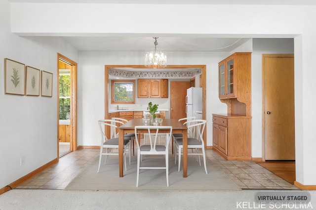 226 Palms St SW, Grand Rapids, MI 49548 - dining room with a chandelier and baseboards