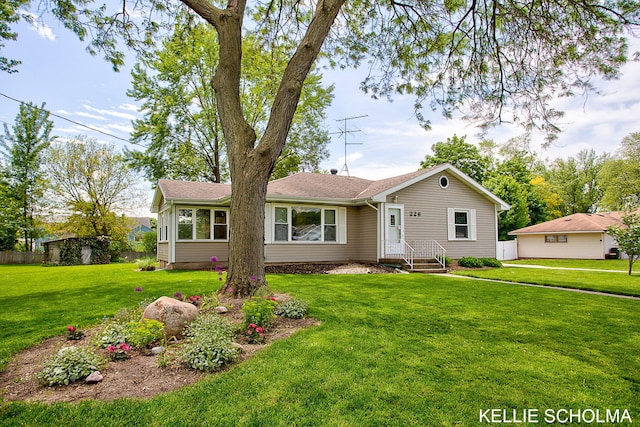 226 Palms St SW, Grand Rapids, MI 49548 - ranch-style house with a front yard and a shingled roof