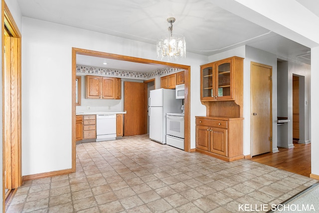 226 Palms St SW, Grand Rapids, MI 49548 - kitchen with white appliances, light stone finish floors, baseboards, glass insert cabinets, and a chandelier