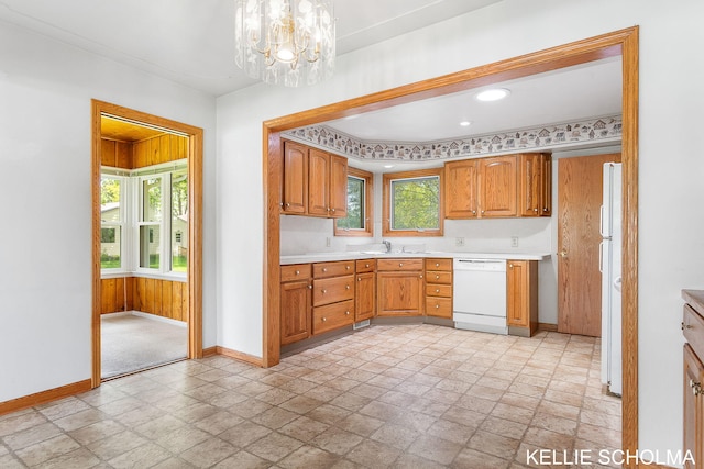226 Palms St SW, Grand Rapids, MI 49548 - kitchen featuring white appliances, baseboards, light stone finish floors, and light countertops