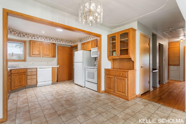 226 Palms St SW, Grand Rapids, MI 49548 - kitchen featuring white appliances, light countertops, glass insert cabinets, brown cabinets, and baseboards