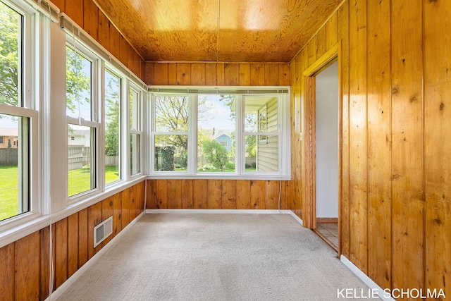 226 Palms St SW, Grand Rapids, MI 49548 - unfurnished sunroom with wooden walls, healthy amount of natural light, carpet floors, baseboards, and wood ceiling