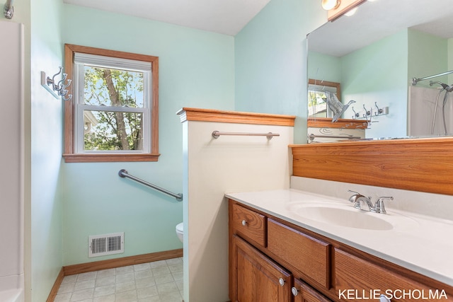 226 Palms St SW, Grand Rapids, MI 49548 - bathroom featuring toilet, vanity, healthy amount of natural light, and baseboards