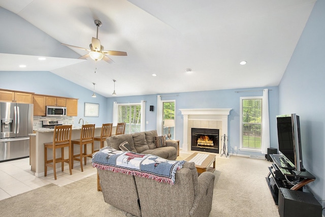 16448 Van Wagoner Rd, Spring Lake, MI 49456 - living room featuring vaulted ceiling, a tile fireplace, ceiling fan, recessed lighting, and light carpet