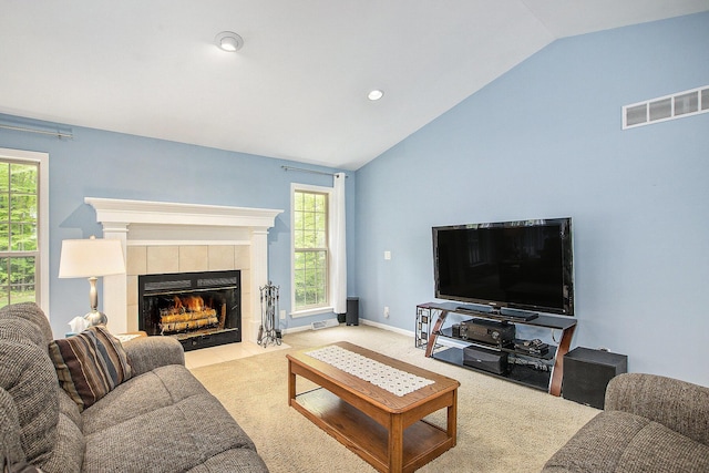 16448 Van Wagoner Rd, Spring Lake, MI 49456 - living area featuring vaulted ceiling, a fireplace, healthy amount of natural light, light carpet, and baseboards