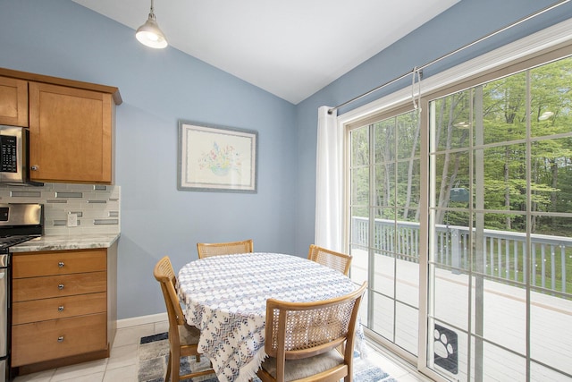 16448 Van Wagoner Rd, Spring Lake, MI 49456 - dining room with vaulted ceiling, healthy amount of natural light, baseboards, and light tile patterned floors