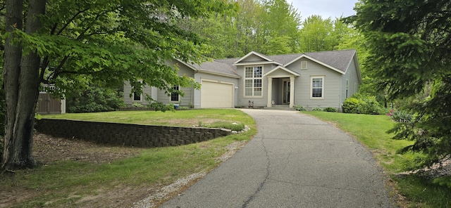 16448 Van Wagoner Rd, Spring Lake, MI 49456 - view of front facade with a garage, asphalt driveway, and a front lawn