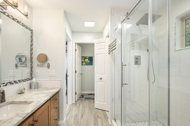 16448 Van Wagoner Rd, Spring Lake, MI 49456 - full bathroom with vanity, a shower stall, wood finished floors, and baseboards