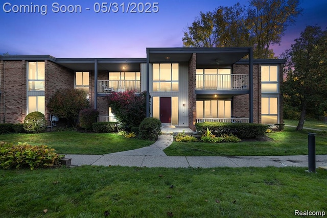 4041 W Maple Rd Apt 204, Bloomfield Hills, MI 48301 - view of front of property featuring a balcony, a lawn, and brick siding