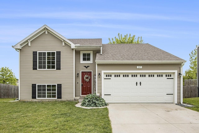 207 Station Hill St, Galesburg, MI 49053 - split level home featuring driveway, an attached garage, and a shingled roof