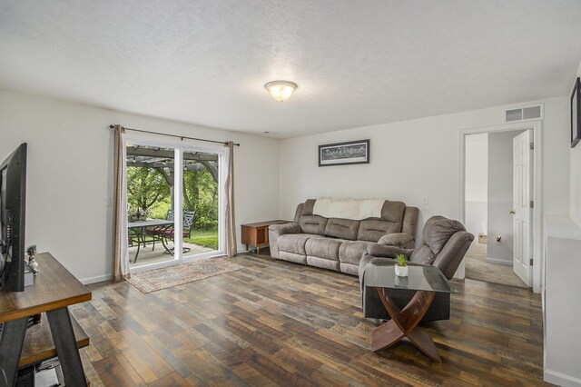207 Station Hill St, Galesburg, MI 49053 - living room with dark wood-style floors, baseboards, and a textured ceiling