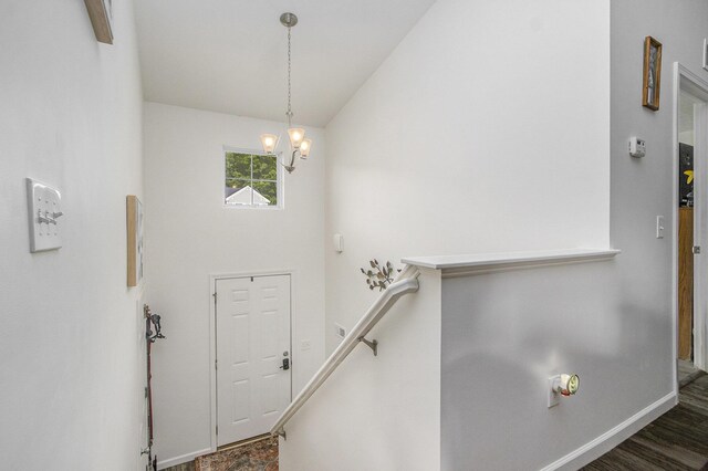 207 Station Hill St, Galesburg, MI 49053 - foyer entrance with a chandelier, baseboards, vaulted ceiling, and wood finished floors