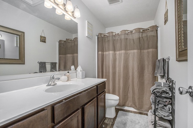 207 Station Hill St, Galesburg, MI 49053 - bathroom with vanity, toilet, a shower with shower curtain, and tile patterned flooring
