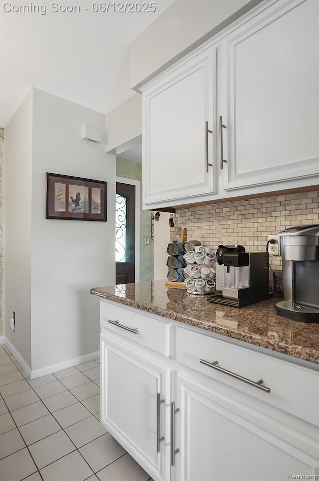 1140 W Lemont Ct, Canton, MI 48187 - kitchen featuring backsplash, light tile patterned flooring, white cabinets, dark stone countertops, and baseboards