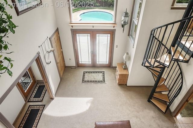 1140 W Lemont Ct, Canton, MI 48187 - carpeted entrance foyer featuring a towering ceiling, stairway, french doors, and baseboards