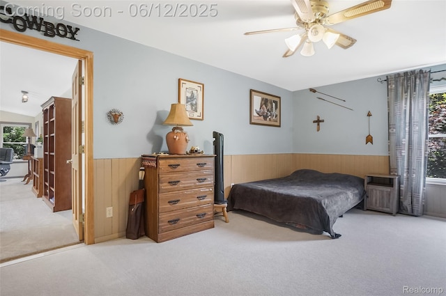 1140 W Lemont Ct, Canton, MI 48187 - carpeted bedroom with multiple windows, wainscoting, wood walls, vaulted ceiling, and a ceiling fan