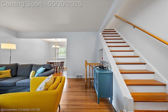 731 N Eton St, Birmingham, MI 48009 - living room featuring a chandelier, wood finished floors, stairs, and baseboards