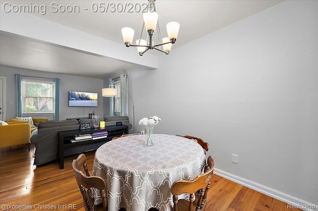 731 N Eton St, Birmingham, MI 48009 - dining space featuring a chandelier, wood finished floors, and baseboards