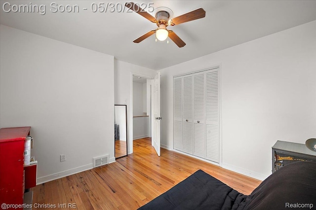 731 N Eton St, Birmingham, MI 48009 - bedroom with hardwood / wood-style floors, baseboards, a closet, and a ceiling fan