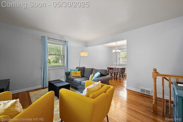 731 N Eton St, Birmingham, MI 48009 - living area featuring plenty of natural light, a chandelier, wood finished floors, and baseboards