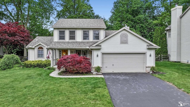 6757 Lockmill Rd, Temperance, MI 48182 - traditional home featuring asphalt driveway, a garage, and a shingled roof