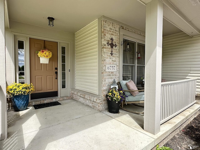 6757 Lockmill Rd, Temperance, MI 48182 - property entrance with covered porch and brick siding