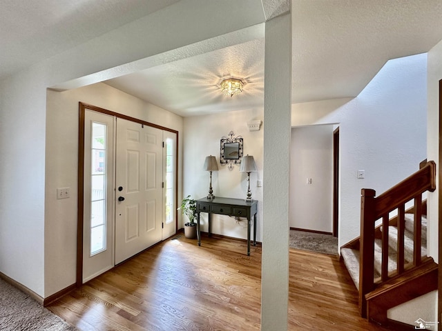6757 Lockmill Rd, Temperance, MI 48182 - foyer with wood finished floors, baseboards, and a textured ceiling