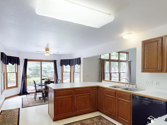 6757 Lockmill Rd, Temperance, MI 48182 - kitchen with black dishwasher, a sink, a textured ceiling, a peninsula, and light countertops