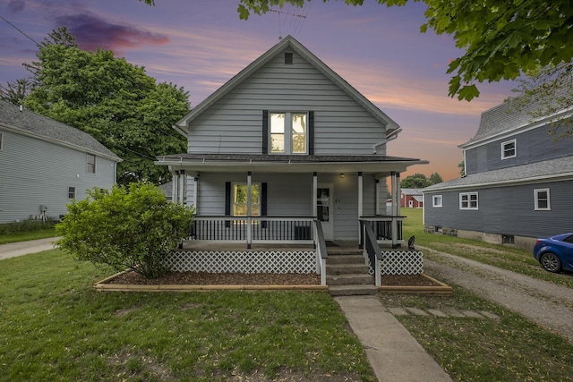 49 S Arthur St, Grant, MI 49327 - view of front of property with a porch and a front lawn