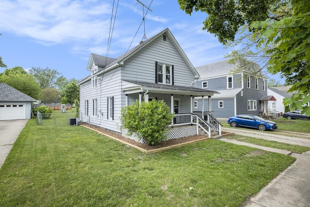 49 S Arthur St, Grant, MI 49327 - view of front of house with a porch, a front lawn, central air condition unit, and a detached garage