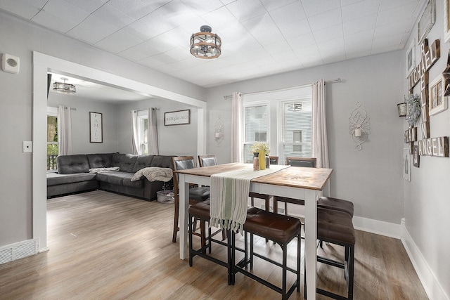 49 S Arthur St, Grant, MI 49327 - dining space with wood finished floors, baseboards, and a chandelier