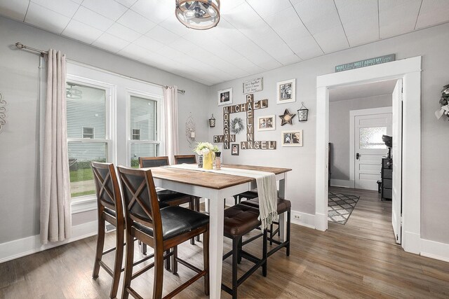 49 S Arthur St, Grant, MI 49327 - dining room featuring wood finished floors, healthy amount of natural light, and baseboards