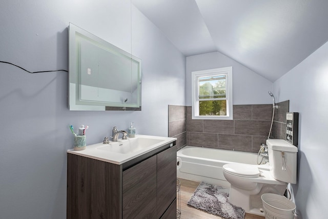 49 S Arthur St, Grant, MI 49327 - bathroom with vaulted ceiling, vanity, toilet, and wood finished floors