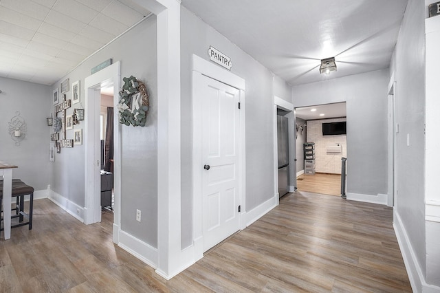 49 S Arthur St, Grant, MI 49327 - corridor with wood finished floors and baseboards