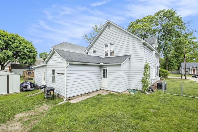 49 S Arthur St, Grant, MI 49327 - rear view of property featuring a shingled roof and central AC
