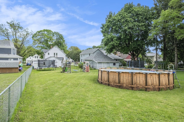 49 S Arthur St, Grant, MI 49327 - view of yard with a trampoline, a playground, and a residential view