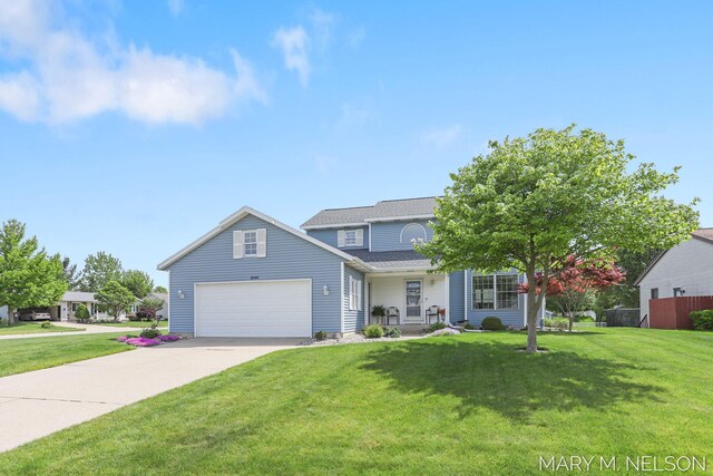 5540 Koster Dr SW, Wyoming, MI 49418 - view of front of home with concrete driveway, a garage, and covered porch