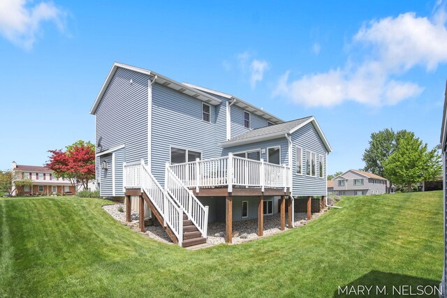 5540 Koster Dr SW, Wyoming, MI 49418 - rear view of house with a deck, a lawn, and stairs