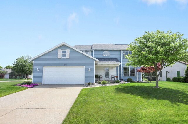 5540 Koster Dr SW, Wyoming, MI 49418 - traditional-style house with a front yard, driveway, and a garage