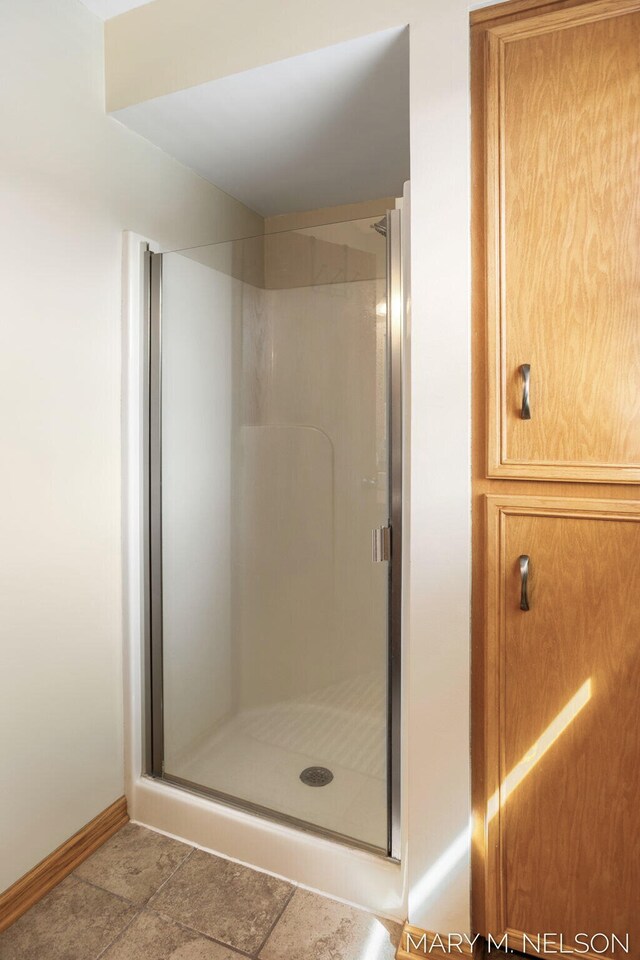 5540 Koster Dr SW, Wyoming, MI 49418 - bathroom featuring baseboards and a stall shower