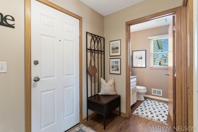 5540 Koster Dr SW, Wyoming, MI 49418 - foyer entrance featuring dark wood-style flooring and baseboards