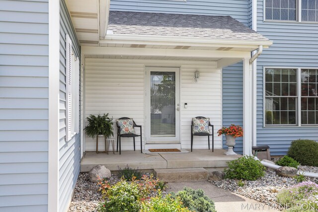 5540 Koster Dr SW, Wyoming, MI 49418 - property entrance featuring covered porch and a shingled roof