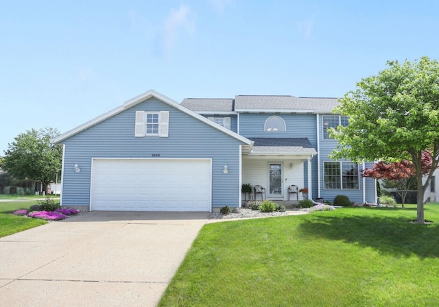 5540 Koster Dr SW, Wyoming, MI 49418 - traditional home with a front lawn, a garage, and concrete driveway