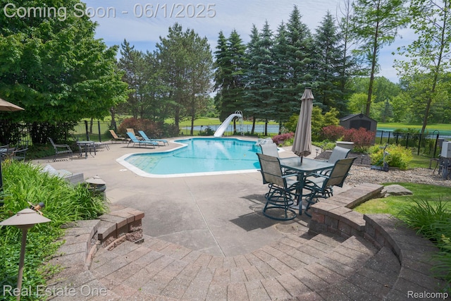 39888 Brylor, Clinton Township, MI 48038 - view of swimming pool featuring a water slide, a patio, and view of scattered trees