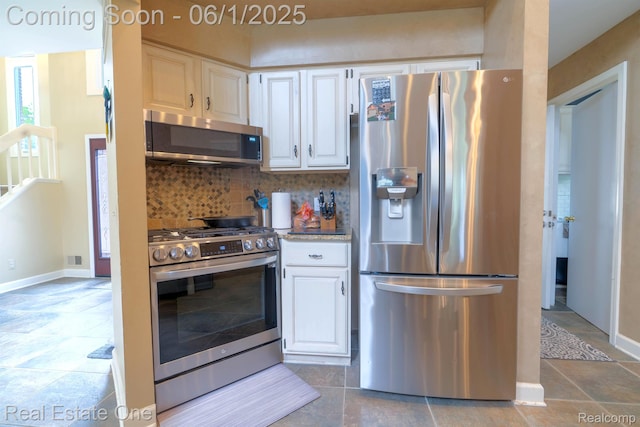 39888 Brylor, Clinton Township, MI 48038 - kitchen featuring appliances with stainless steel finishes, tasteful backsplash, white cabinetry, and baseboards