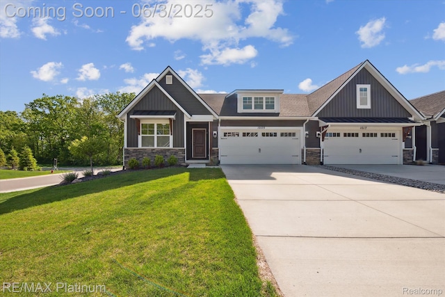 1009 Camellia Cir, Howell, MI 48843 - craftsman-style home with stone siding, concrete driveway, a front yard, and board and batten siding
