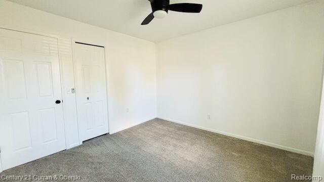 45215 Custer Ave, Utica, MI 48317 - unfurnished bedroom featuring carpet floors, a closet, baseboards, and ceiling fan