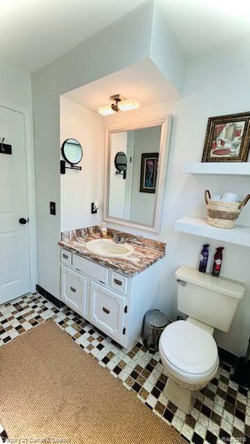 45215 Custer Ave, Utica, MI 48317 - half bath featuring toilet, vanity, and tile patterned floors