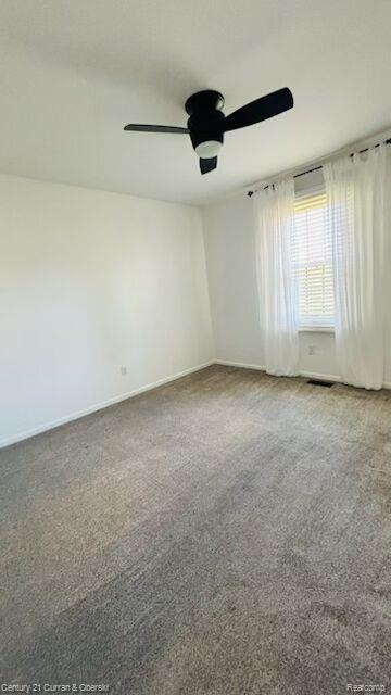 45215 Custer Ave, Utica, MI 48317 - spare room featuring a ceiling fan, carpet floors, and baseboards